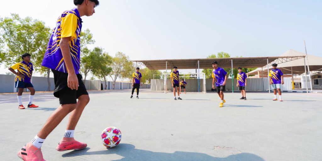 "Students playing football at Wise Indian Private School Umm Al Quwain"